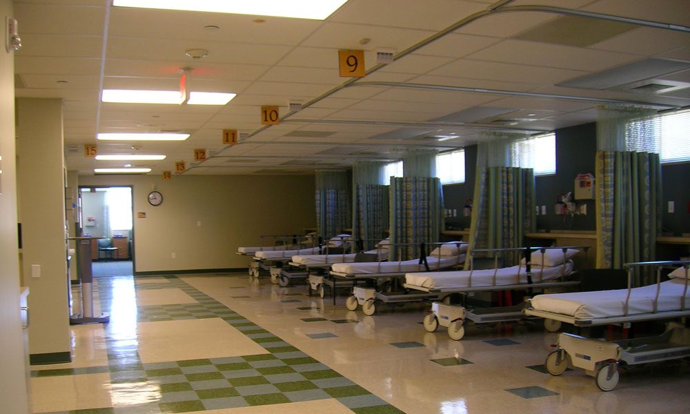 hospital interior with lines of beds waiting for patients