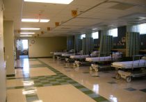 hospital interior with lines of beds waiting for patients