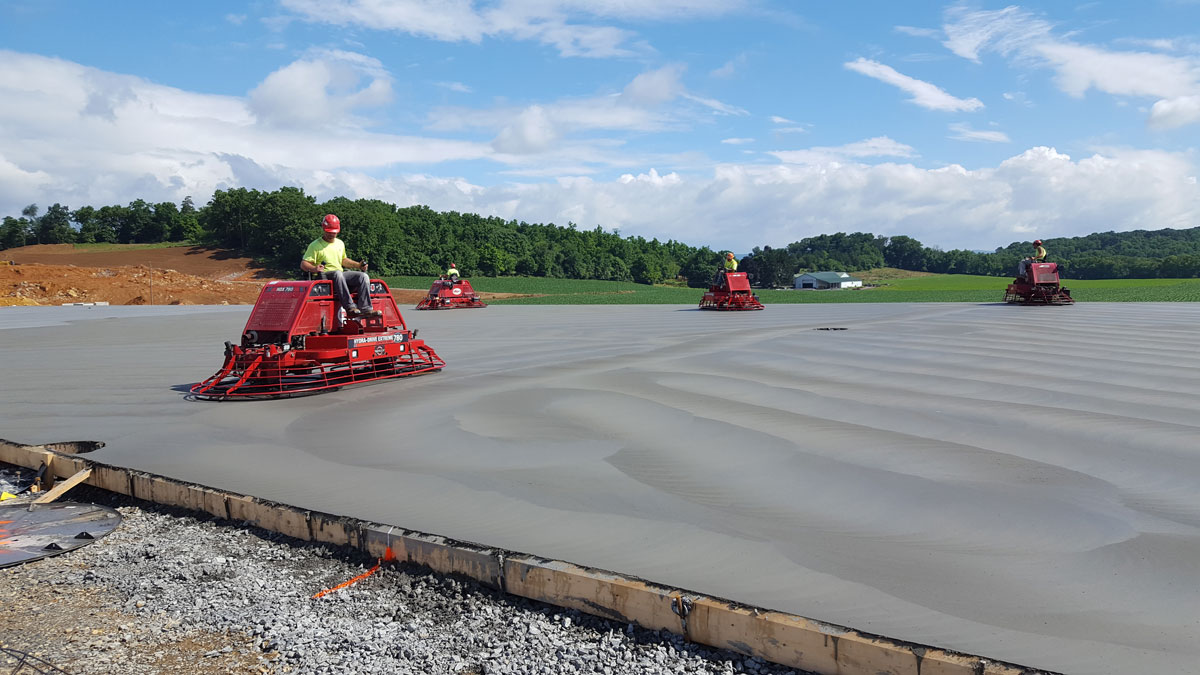 Penntex team members working on finishing a concrete pad