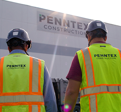 Penntex Employees from back wearing high vis vests and hard hats