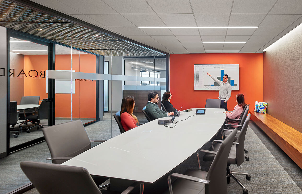 conference room with people reviewing a presentation