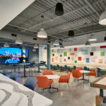 interior office gathering area with chairs and colorful wall accents
