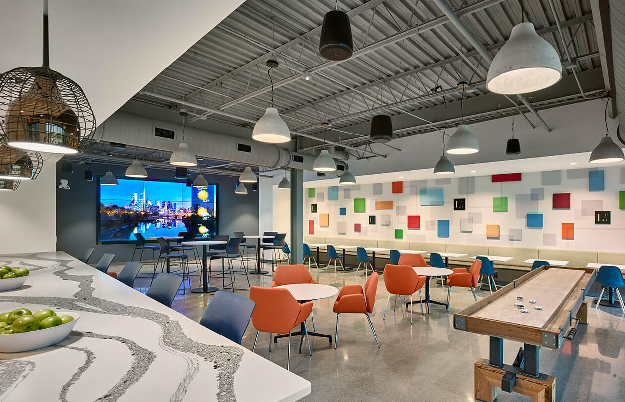 interior office gathering area with chairs and colorful wall accents