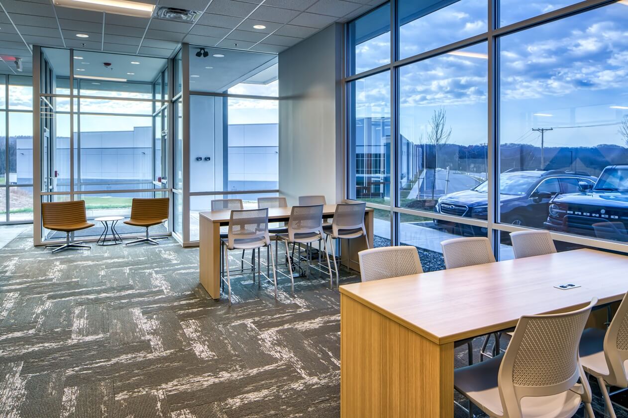 Office interior view with tables and chairs, view to exterior