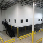 view of second story enclosed mezzanine in a warehouse space