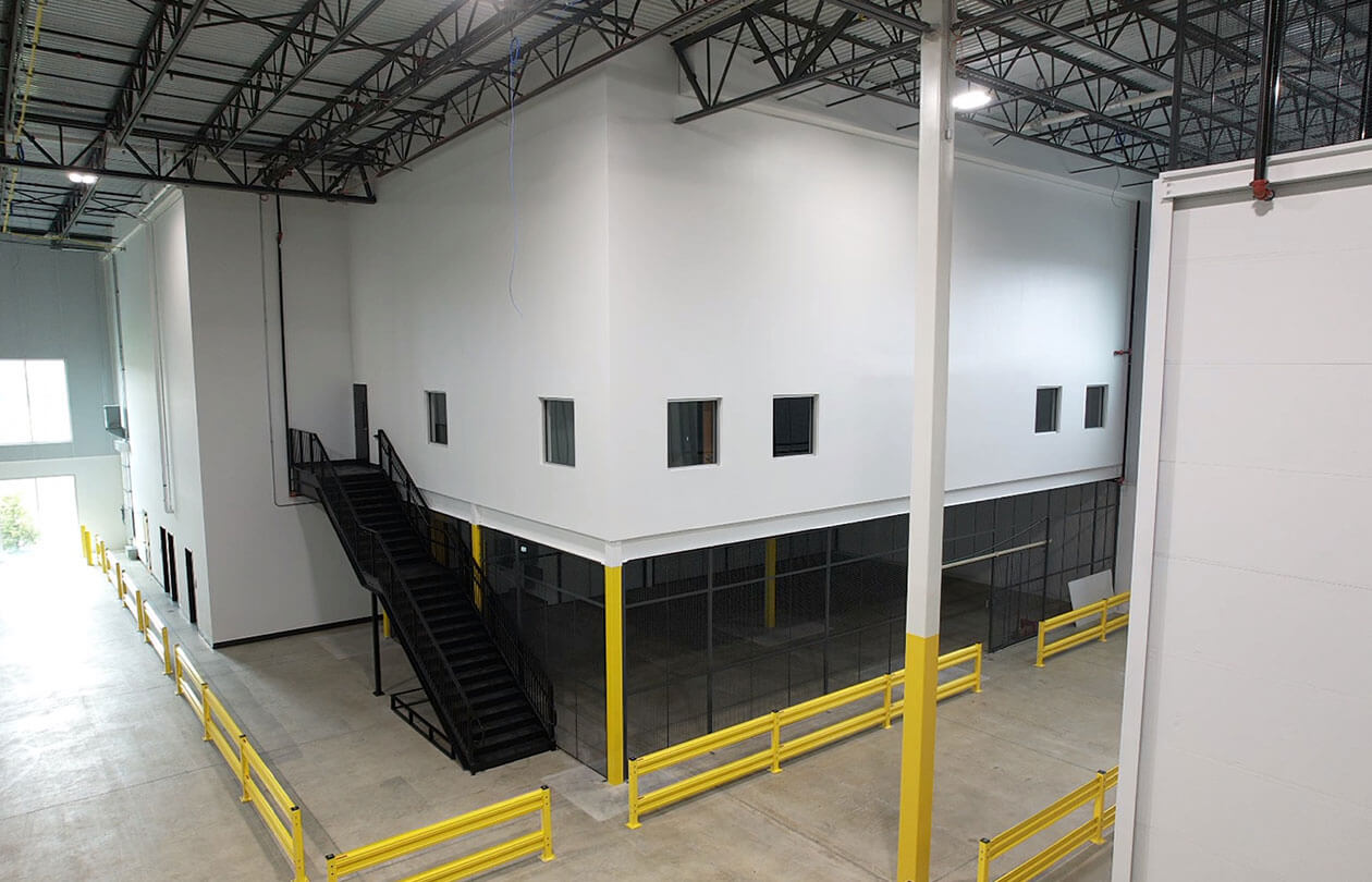 view of second story enclosed mezzanine in a warehouse space