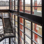 view of metal stairs inside a building surrounded by windows