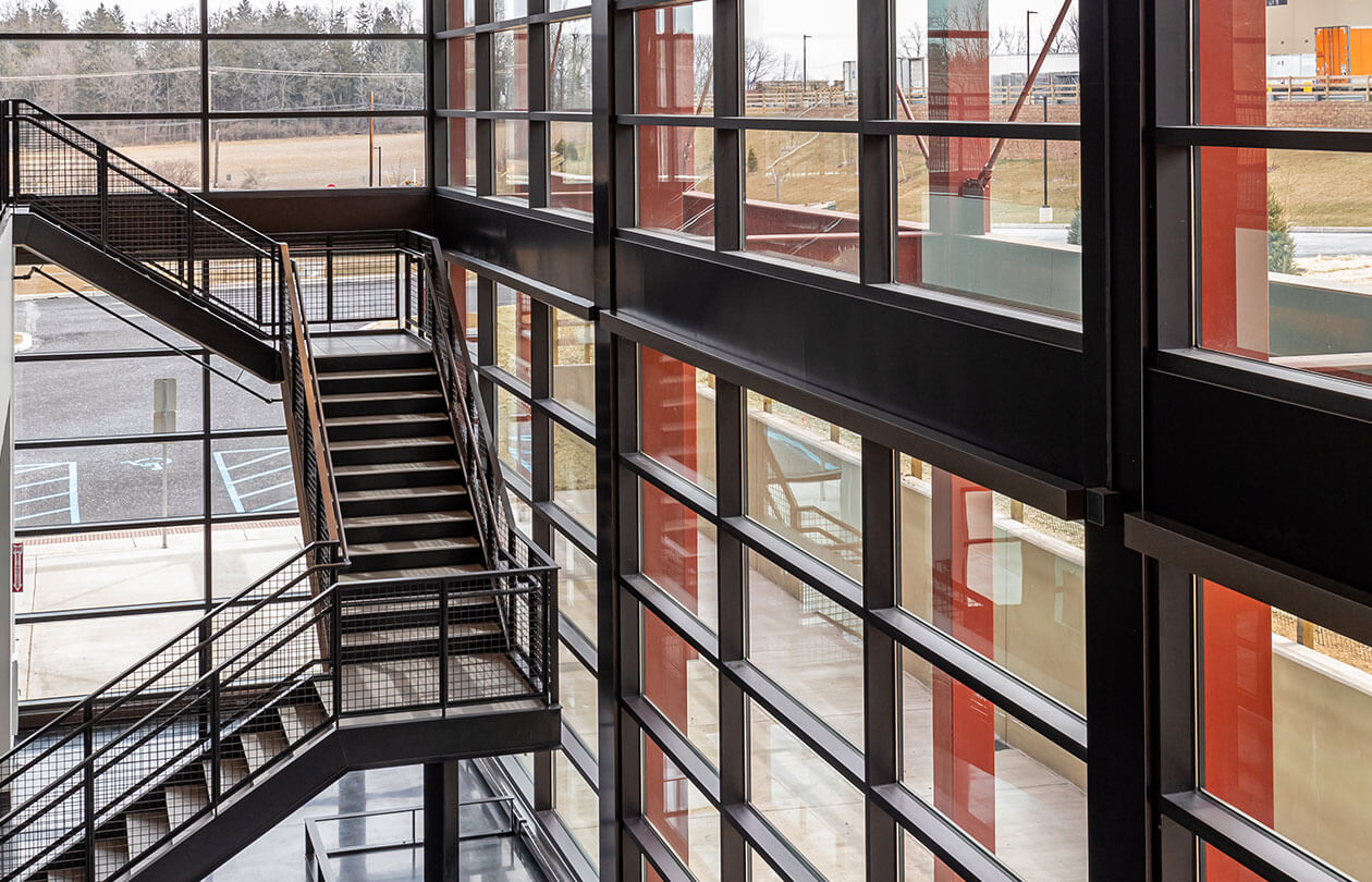 view of metal stairs inside a building surrounded by windows