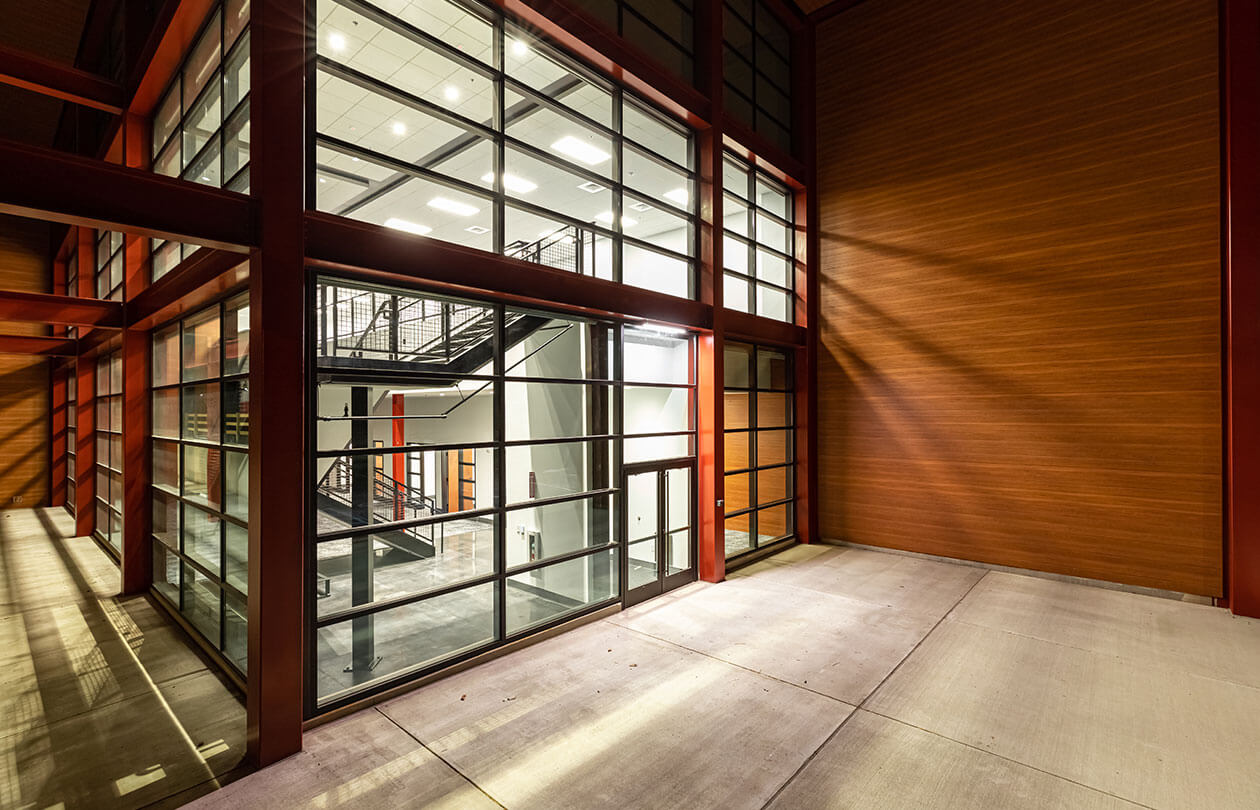 Unique warehouse entrance with large window walls view to interior stairs