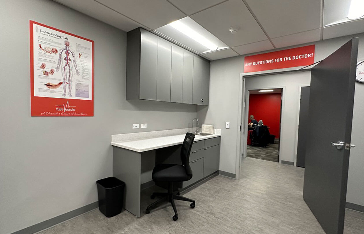 Doctor's office view with chair and desk that looks into the hallway