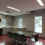 break room with kitchen and table with chairs
