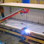 Person welding a large container