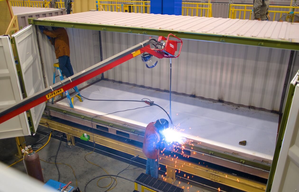 Person welding a large container
