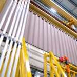 view looking up at large containers on production floor