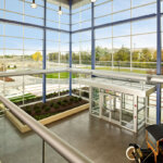 Interior lobby with large windows and antique car
