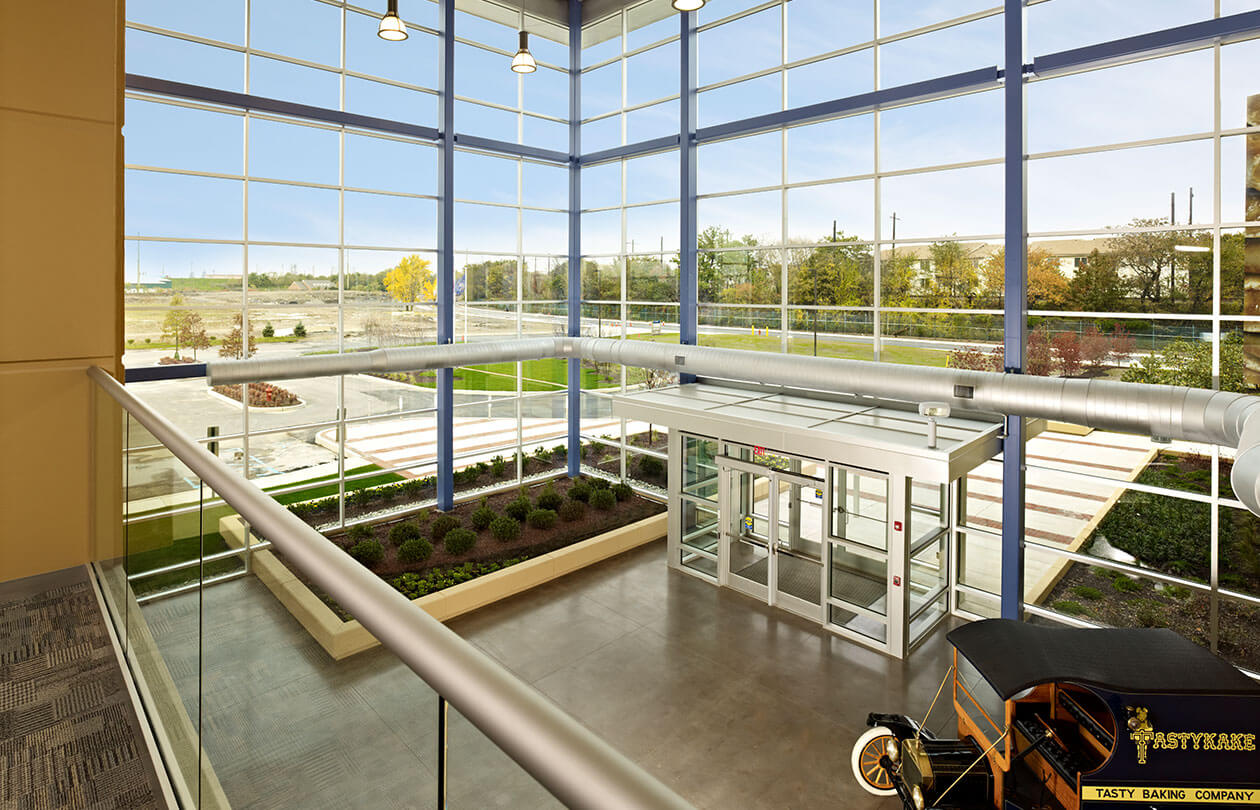 Interior lobby with large windows and antique car