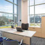 office view with desk and chairs looking out the window