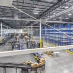 warehouse racking and conveyors through steel beams