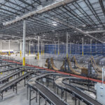 wide view of warehouse with racking and conveyors