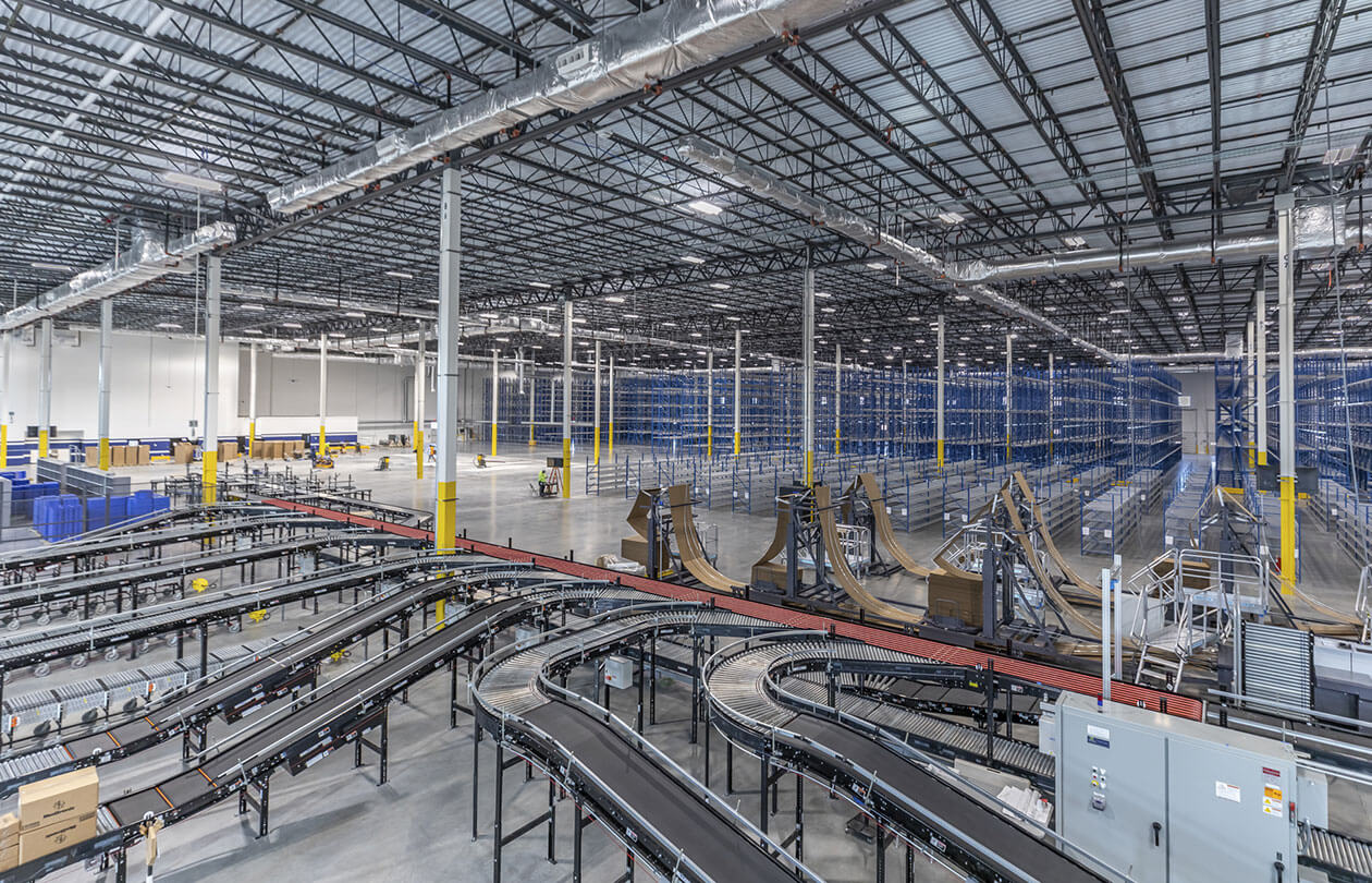 wide view of warehouse with racking and conveyors