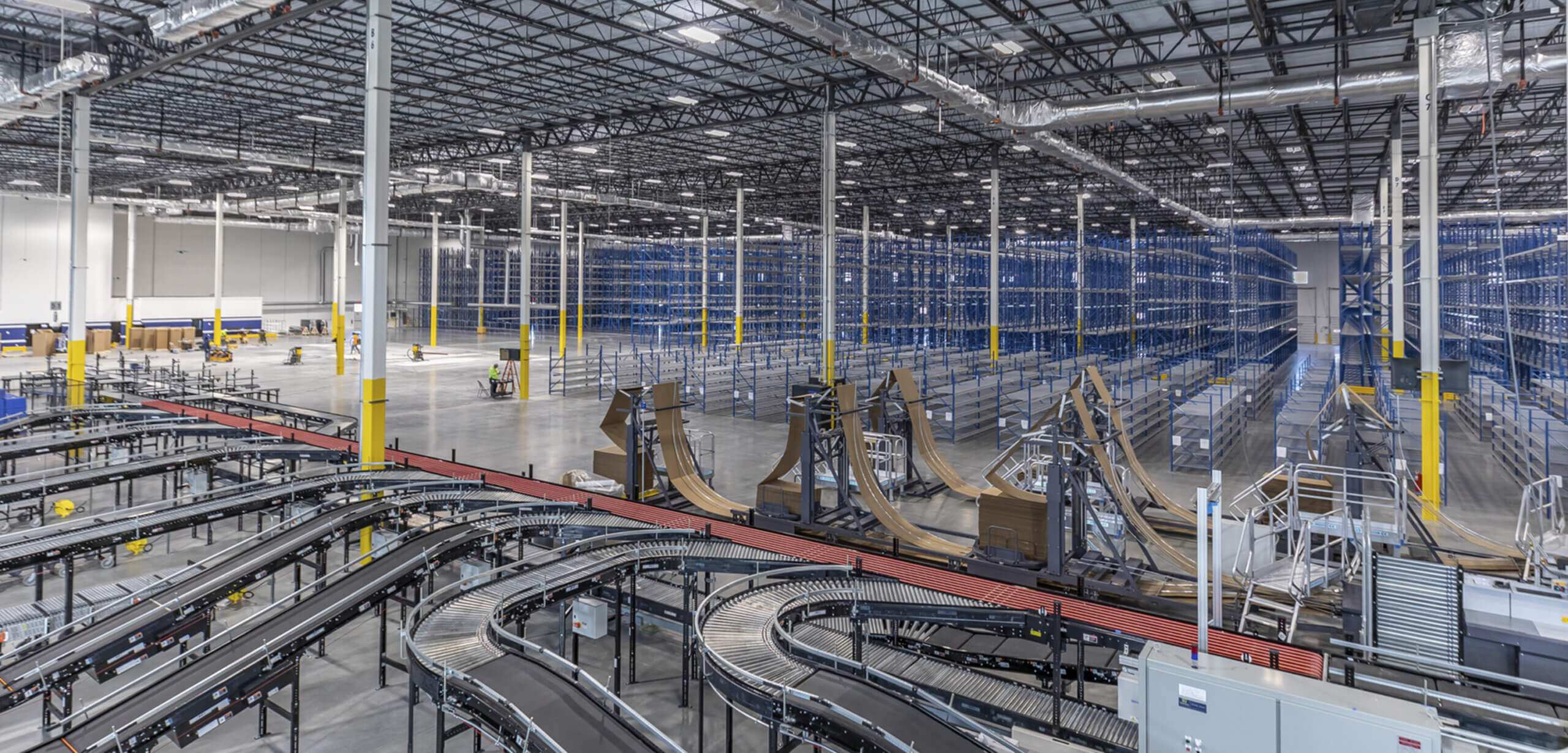 commodore warehouse with exposed steel beams and conveyor belt bg image scaled