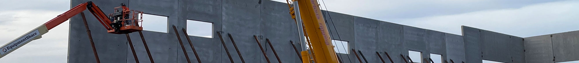 construction workers on crane at work site