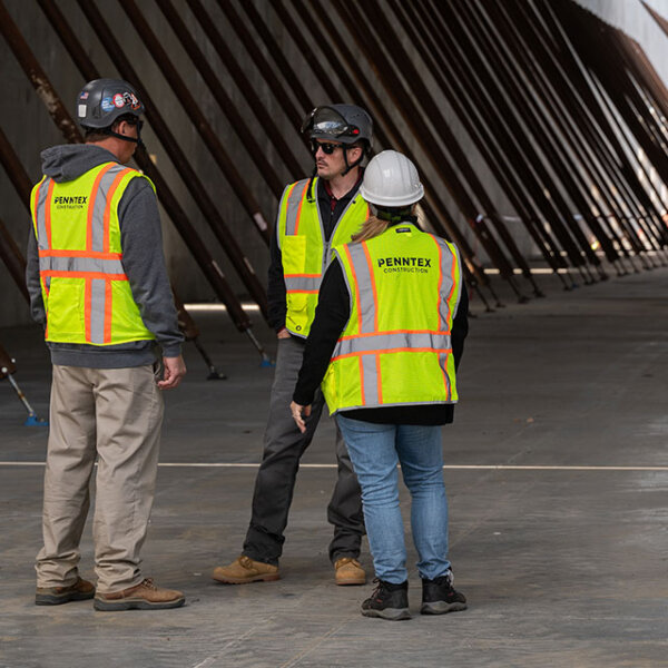 consulting Penntex employees with high vis vests photo bar