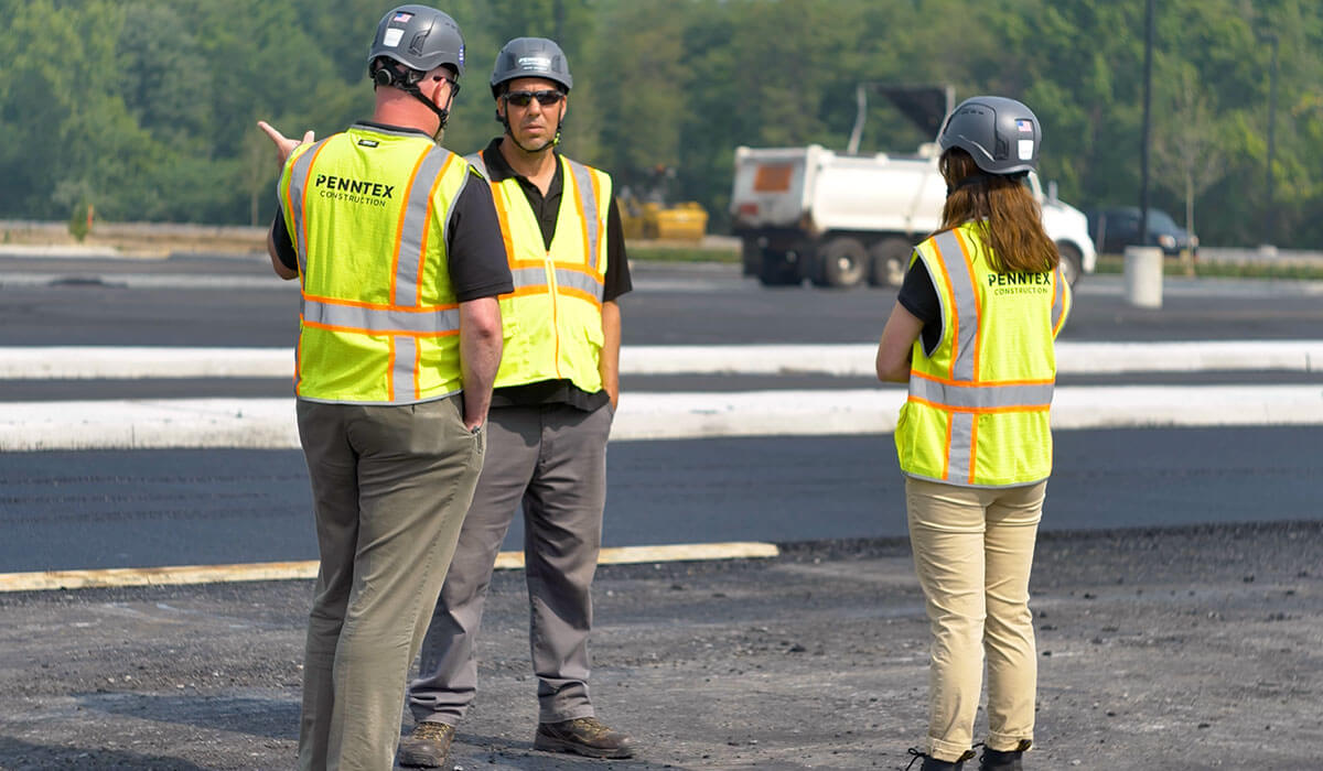 group of 3 penntex employees talking about project