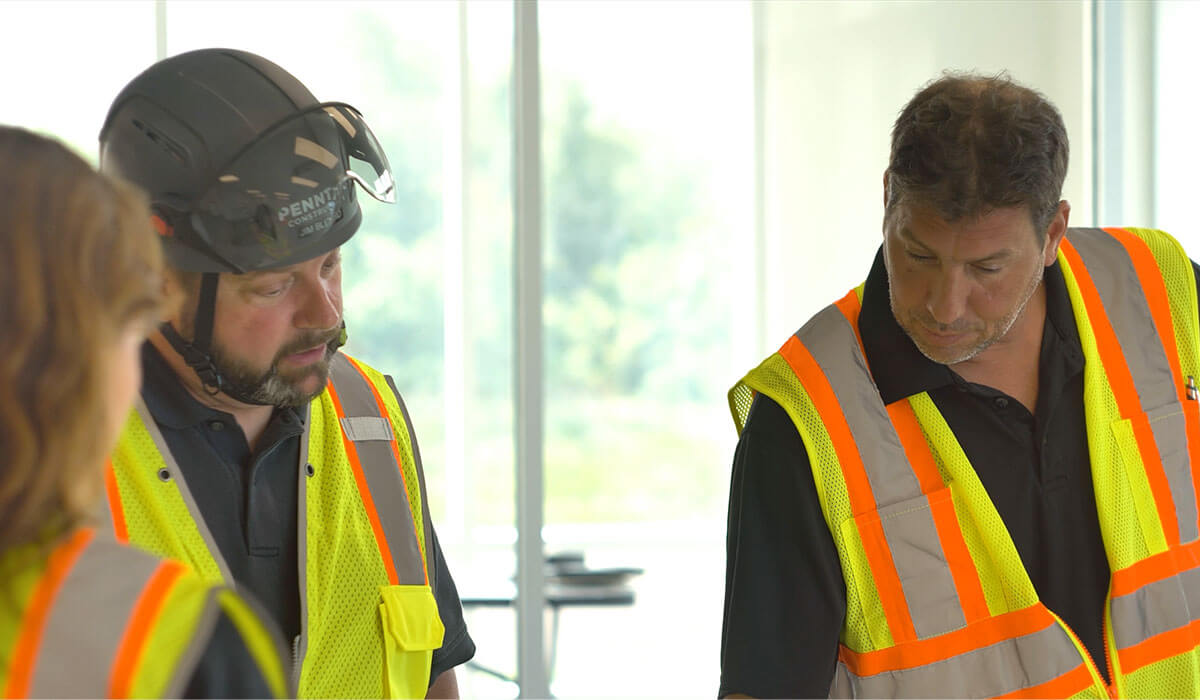 group of employees talking about project in safety gear