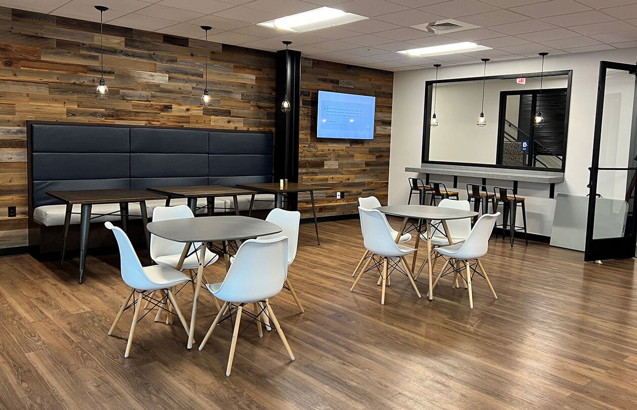 modern interior office gathering space with tables and chairs