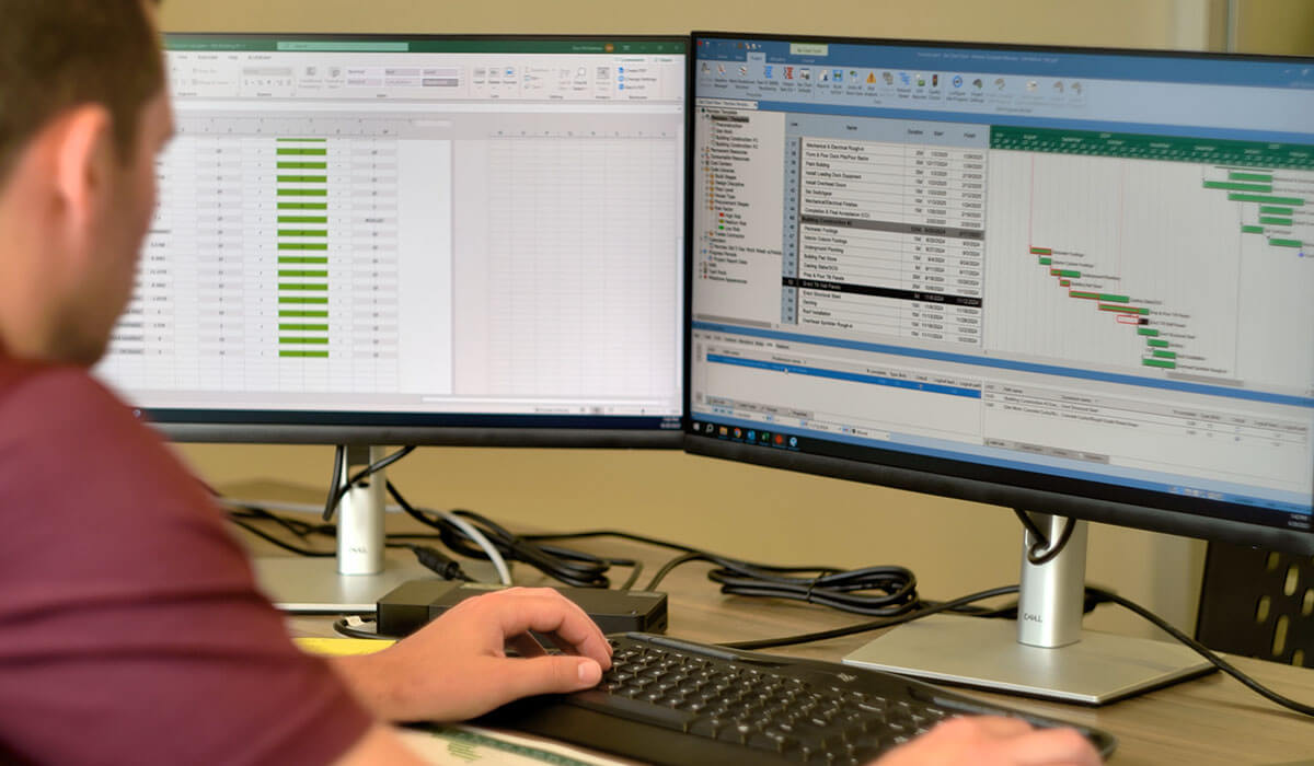 office team on compter looking at spreadsheets