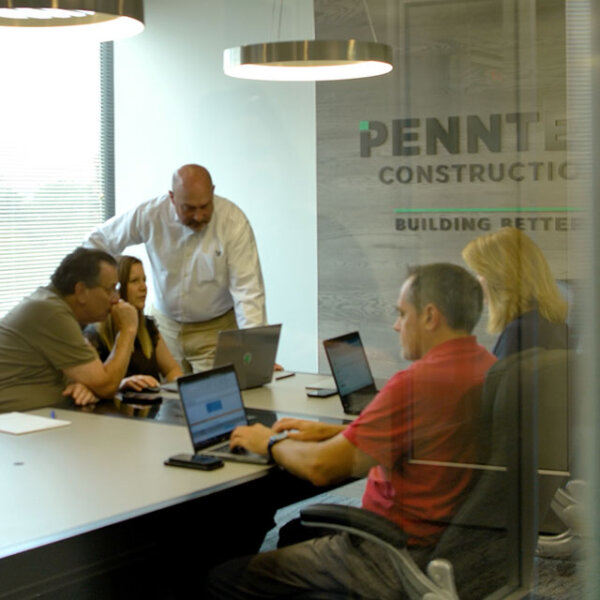 penntex team discussing projects in conference room photo bar