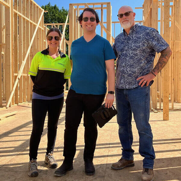 penntex team members smiling in front of building going up photo bar 1