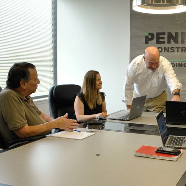 penntex team talking about project in conference room photo bar