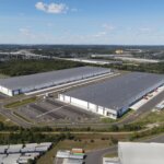 wide shot aerial view of two warehouse facilities side by side