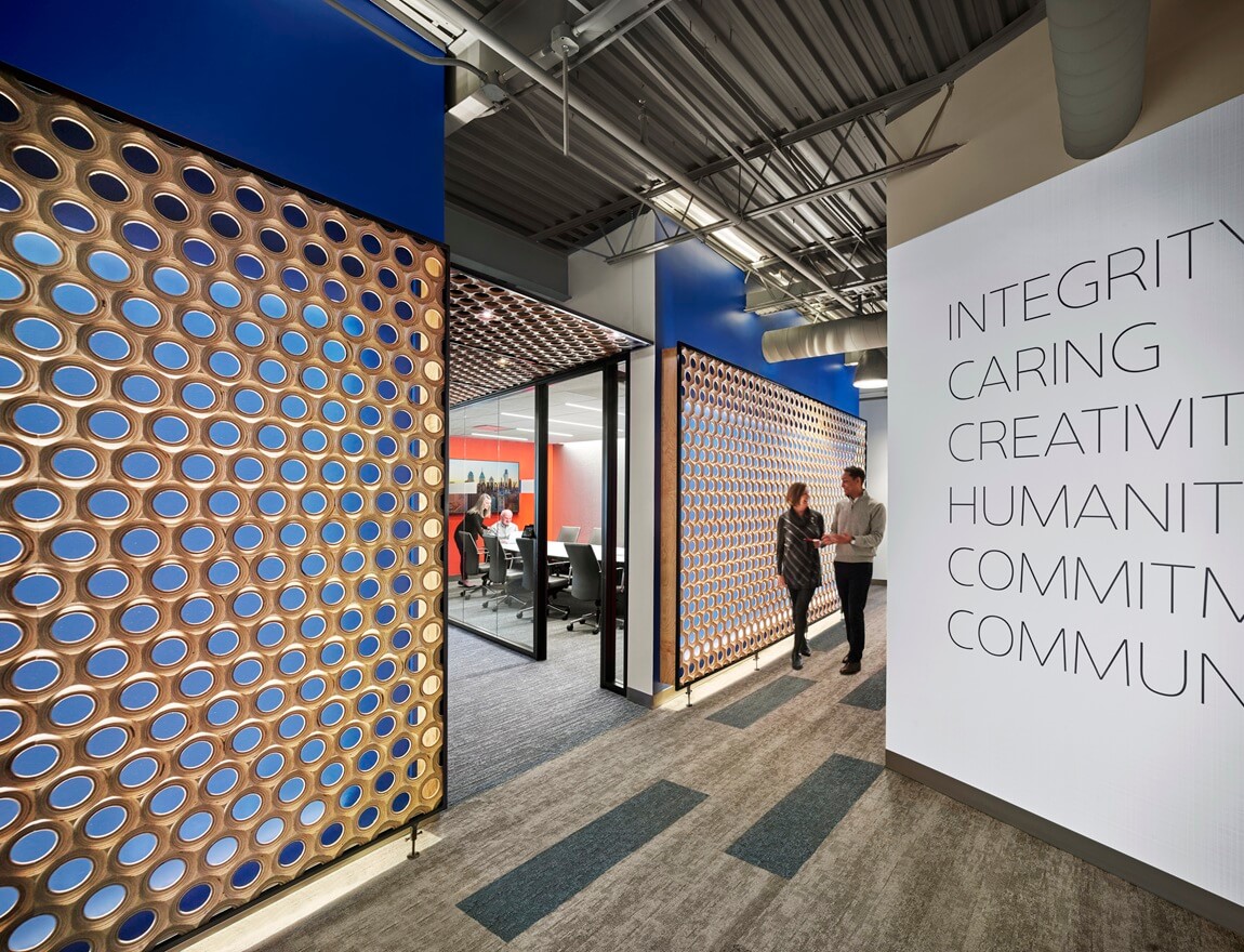 interior office space with quote wall, two people walking