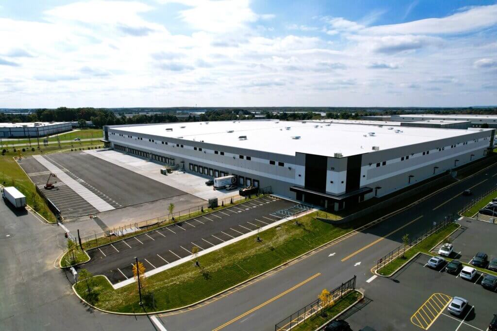 warehouse aerial view with loading docks and trucks