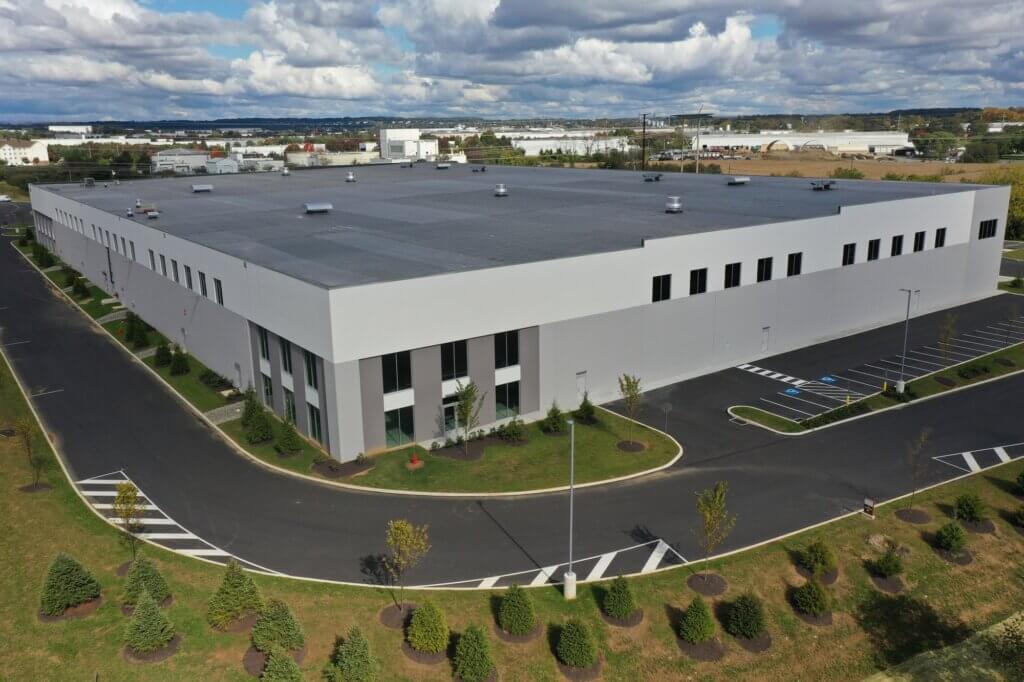 Exterior view of building with surrounding area shot from drone