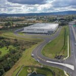exterior aerial view of warehouse facility with roads around it