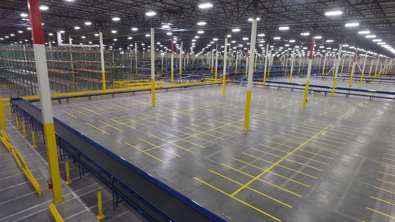 Interior production facility with conveyors and large open space for equipment parking