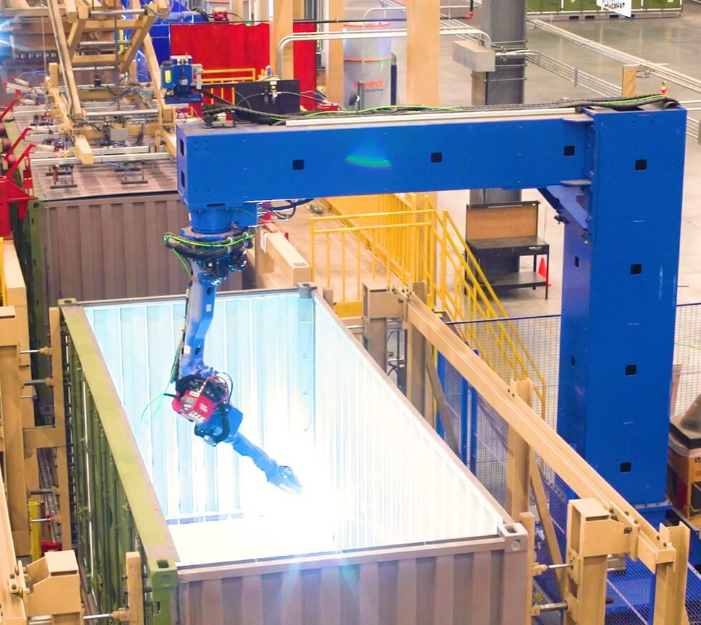 blue robotic welding arm working in container
