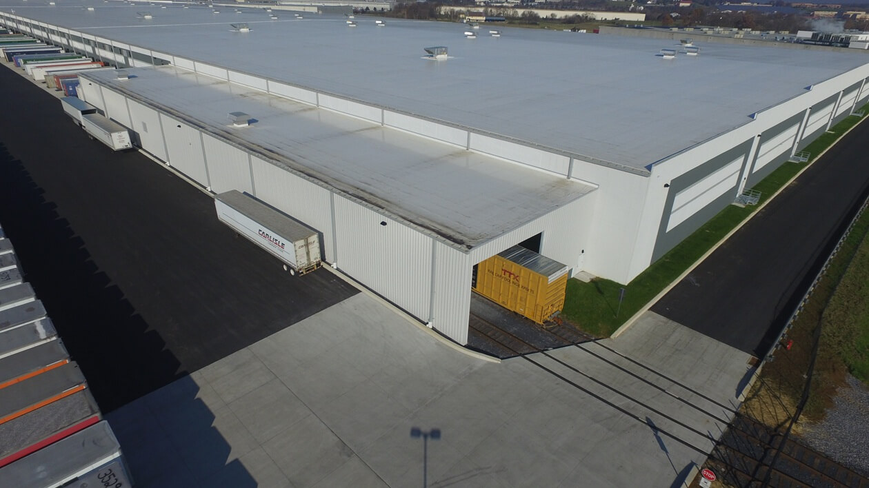 warehouse with train tracks leading into facility