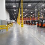 interior warehouse with poles and forklifts