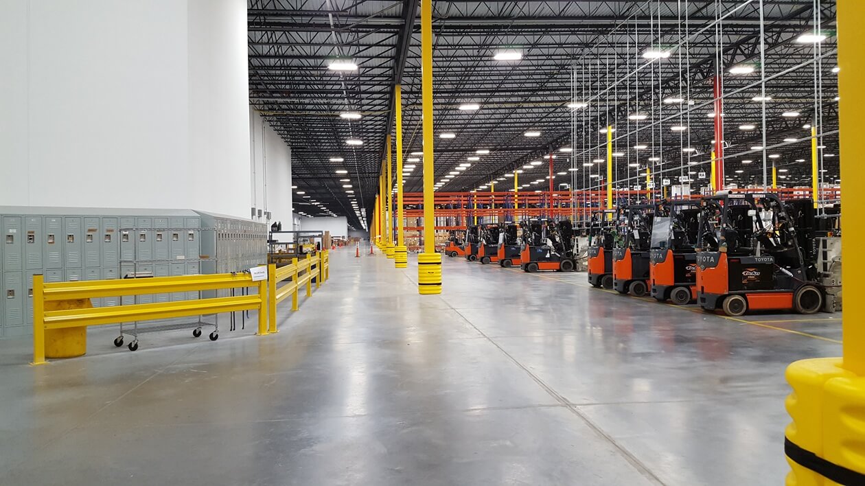 interior warehouse with poles and forklifts